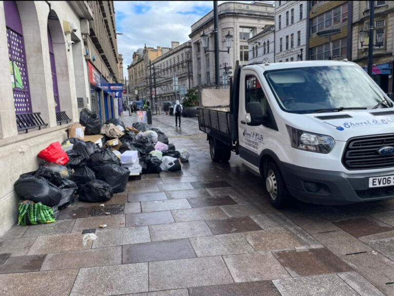 A white van is parked on a city street.