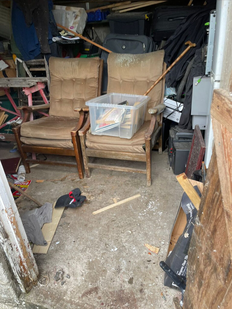 A garage with a lot of junk in it.