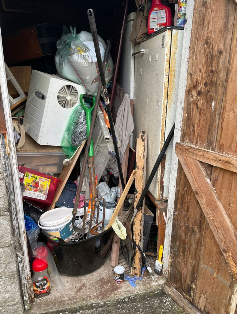 A garage with a lot of junk in it.